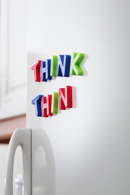 Photo close-up of toy magnets on refrigerator