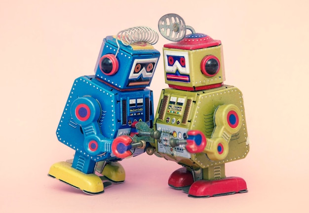 Close-up of toy robots against colored background