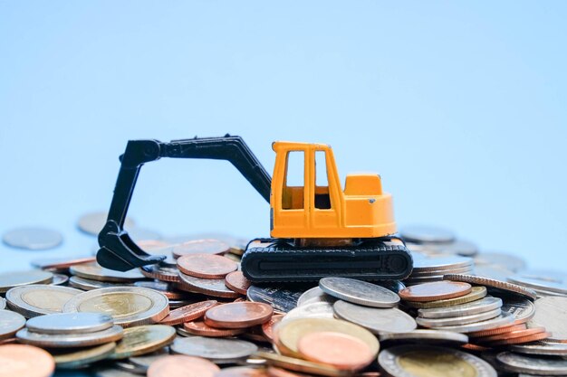 Photo close-up of toy with coins against blue background