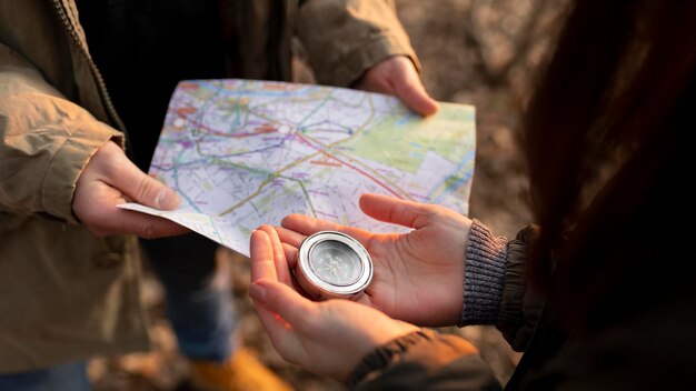 close up travelers with map compass