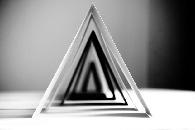 Photo close-up of triangle shape papers arranged in a row on table at home