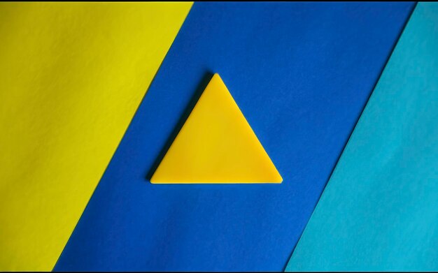 A close up of a triangle on a yellow and blue background