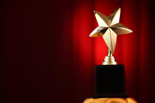 Close-up of trophy against red curtain