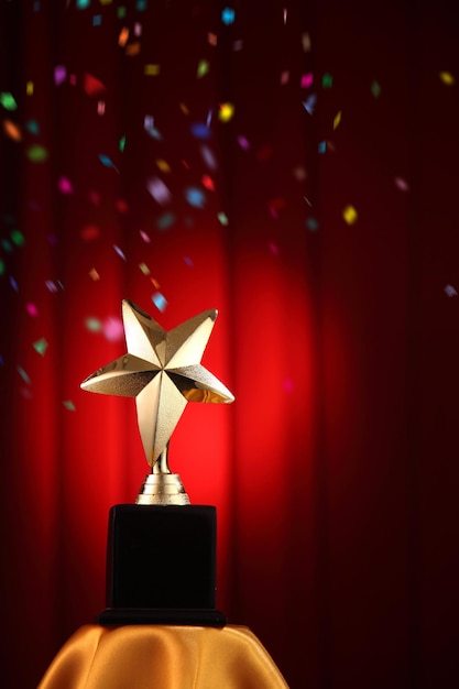 Photo close-up of trophy against red curtain