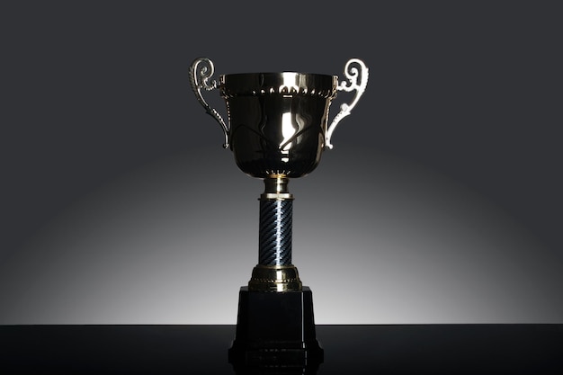 Close-up of trophy on table against gray background