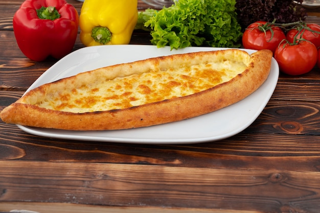 Close up of turkish pide bread on wooden table