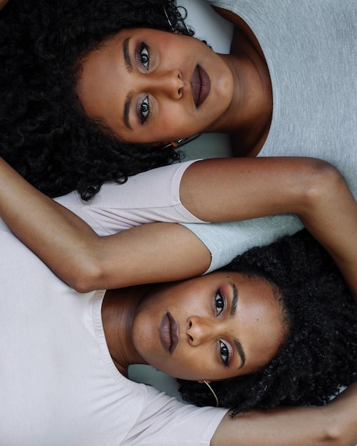 close up two african woman next to each other portrait