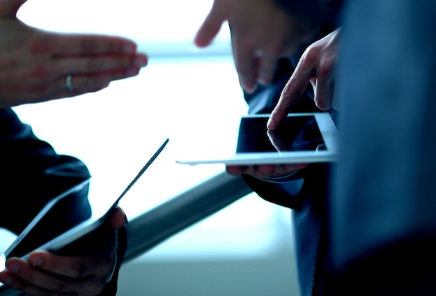 Photo close up. two businessmen with tablet computers