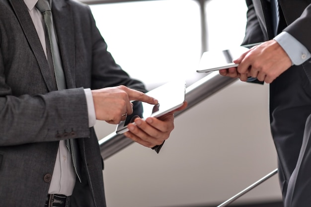 Close up. two businessmen with tablet computers