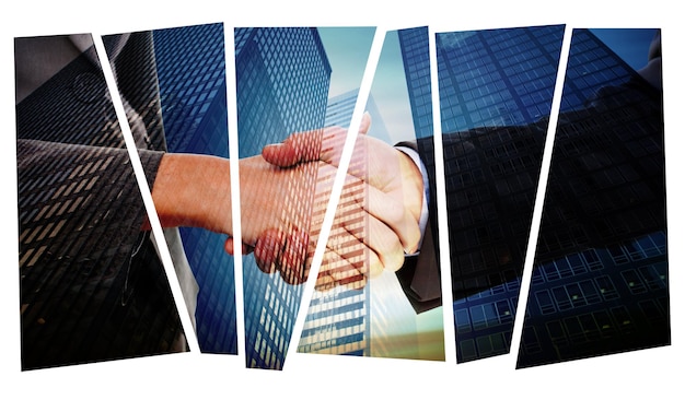 Close up of two businesspeople shaking their hands against low angle view of skyscrapers