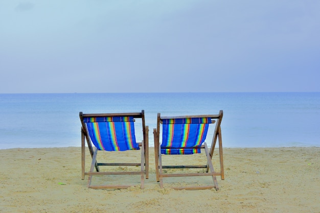 close up two casvas chair on beach with sunny day sea background