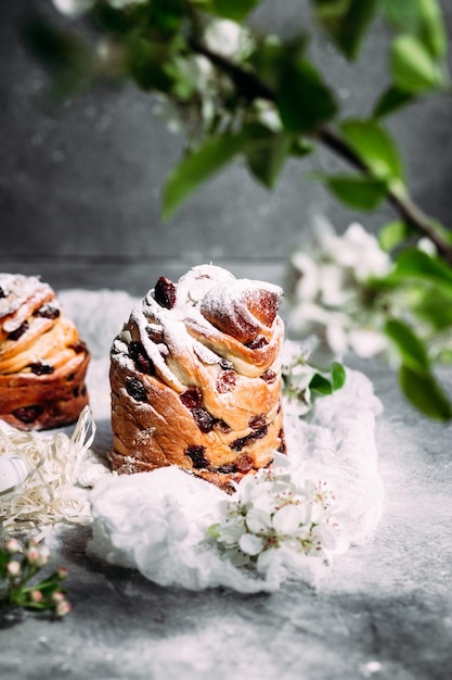 A close up of two croissants with white icing on top