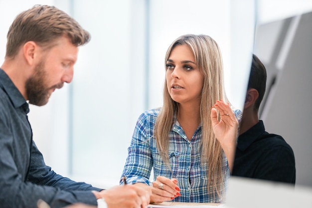 Photo close up. two employees sitting at the desk. office weekdays