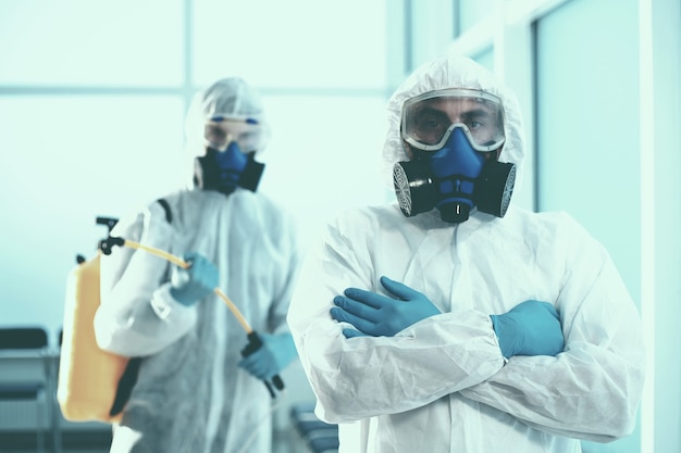 Close-up. two male sanitizers exit the decontaminated room . concept of health protection.