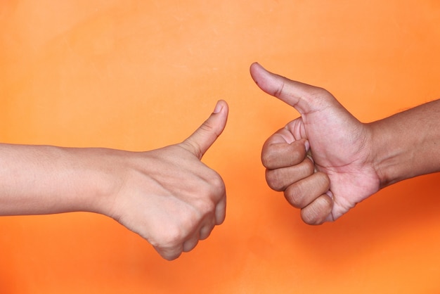 Close up of two people hand showing a thumb-up