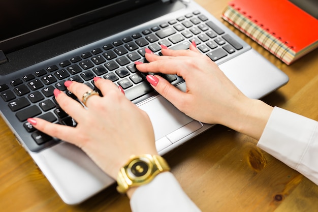 Close-up of typing female hands on keyboard