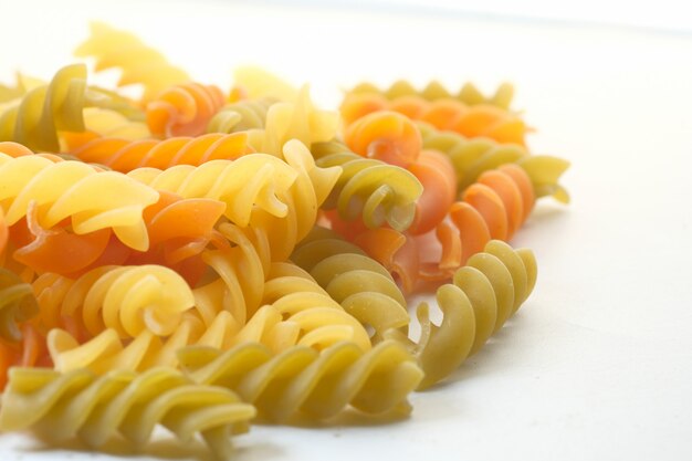 Close up of uncooked macaroni isolated on white.