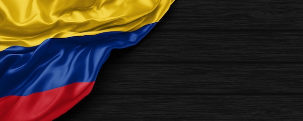 Close up of united states of Colombia flag on the black wooden background 3d render