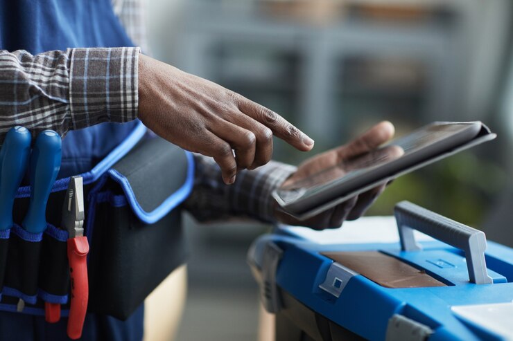Photo close up of unrecognizable african-american worker using digital tablet to put in job details, copy space