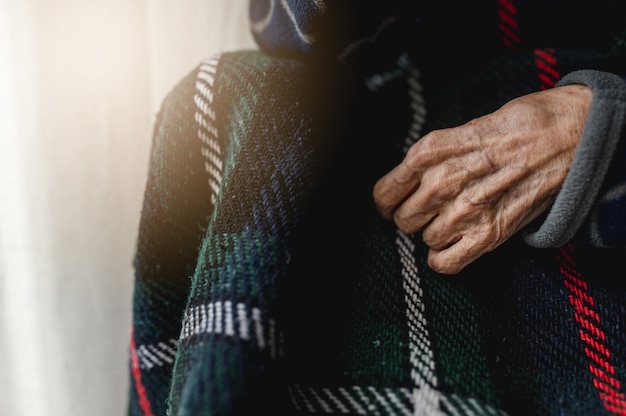 Photo close-up unrecognizable old woman hand. elderly, third age concept.