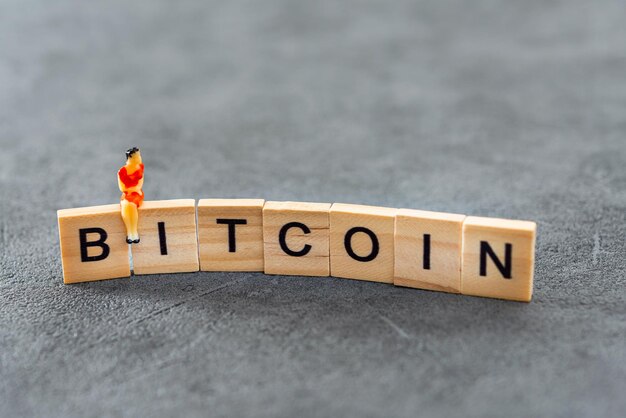 Close-up van bitcoin tekst en vrouwelijk beeldje op tafel