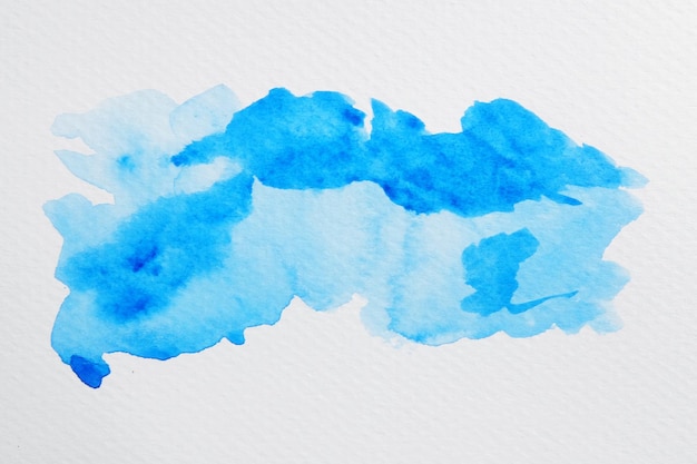 Close-up van blauwe verf op wit papier