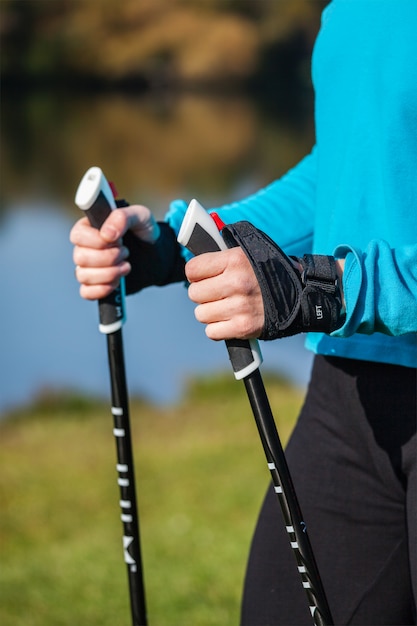 Foto close-up van de hand van de vrouw met nordic walking-stokken