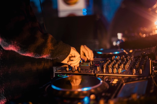 Close-up van de handen van een dj die de mixer bespeelt tijdens een muziekfestival Hoge kwaliteit p