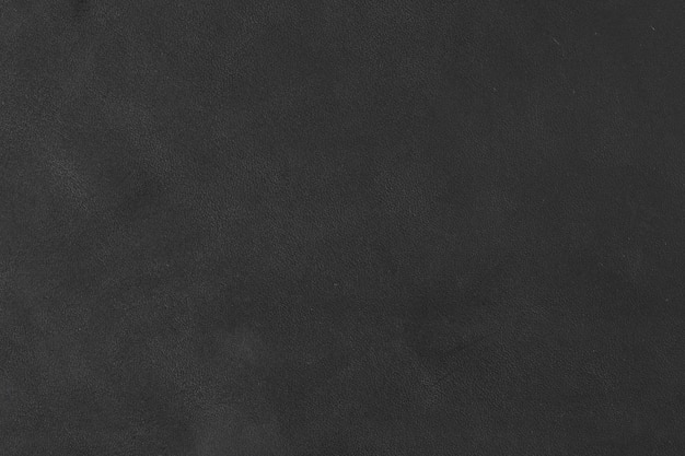 Close-up van een gedeelte van een staal van zwart leer met nerven en een lichtstraal over een foto met hoge resolutie