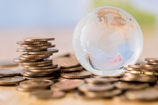 Foto close-up van een glazen bol op munten aan tafel