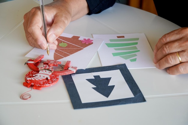 Close-up van een hand die een kerstkaart voor kerstmis schrijft