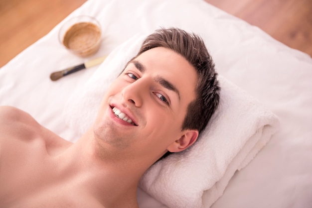 Close-up van een jonge man krijgt spa-behandeling.