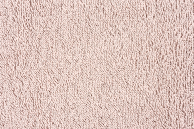 Close-up van een lichtroze handdoek. Textiel details achtergrond.
