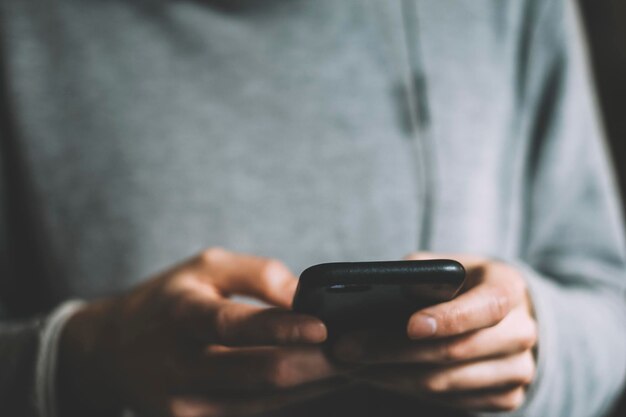Close-up van een man die een mobiele telefoon gebruikt