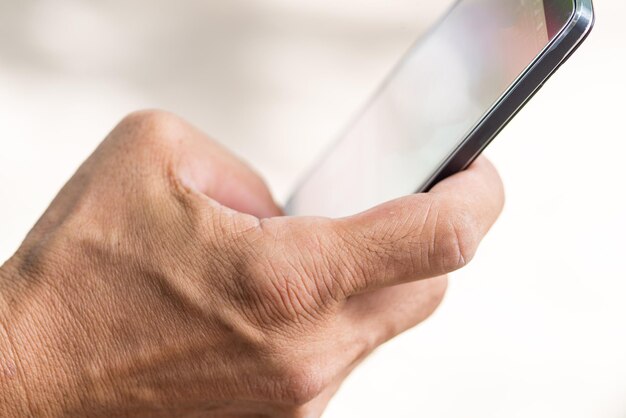 Foto close-up van een man die een mobiele telefoon gebruikt