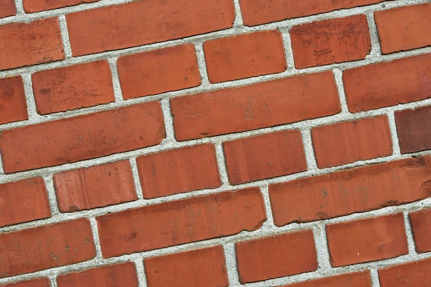 Close-up van een rode bakstenen muur met kopie ruimte Detail van recent gebouwd exterieur metselwerk of historische ontwerp muur achtergrondpatronen en texturen Buiten zoom van moderne industriële stijl architectuur