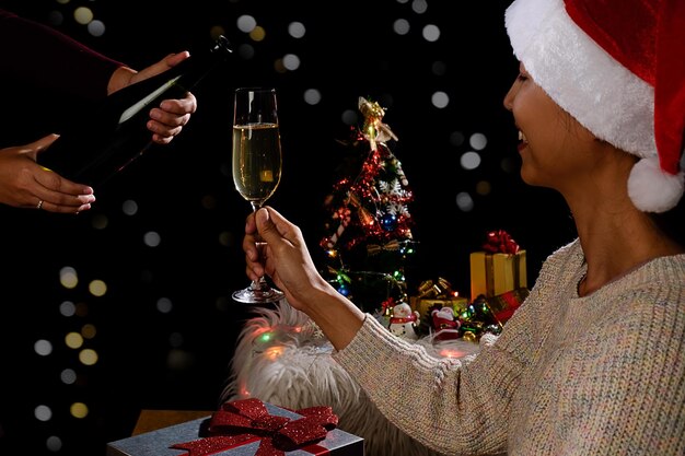 Foto close-up van een vrouw met een champagnefluit tijdens een kerstfeest