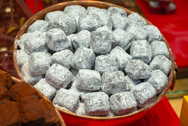 Close-up van enkele van de verschillende soorten voortreffelijke chocolaatjes die te koop zijn in winkels die gespecialiseerd zijn in de beroemde Belgische chocolade