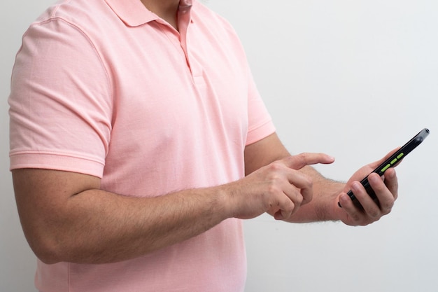 Close-up van geïsoleerde man die hun mobiele telefoon aanraakt met zijaanzicht op witte achtergrond