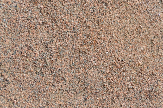 Close-up van gekleurde kleine stenen, zandachtergrond.