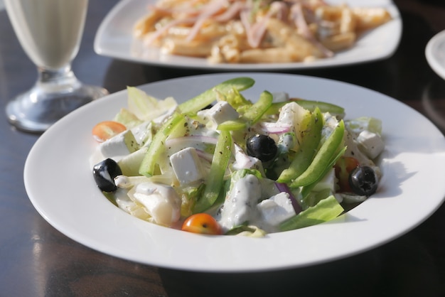 Close-up van griekse salade in een kom op tafel.