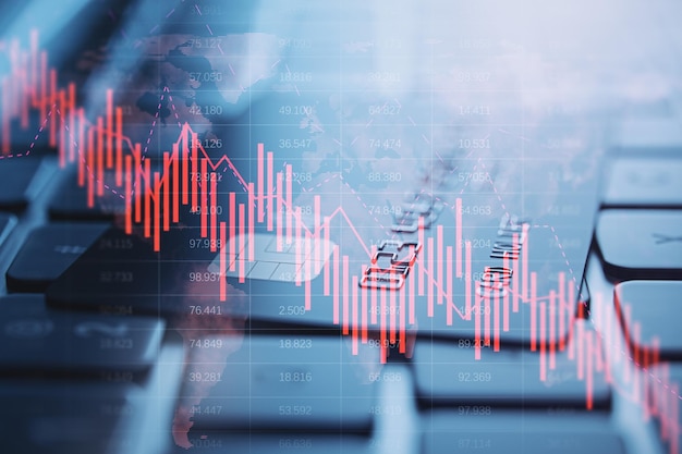 Close-up van het toetsenbord van de notebookcomputer met bankkaart en vallende rode zakelijke grafiekraster op onscherpe achtergrond Crisis, recessie en beursconcept Dubbele belichting