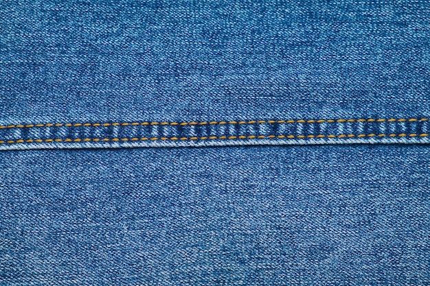 Close-up van jeanstextuur met rechte naad Denim textielachtergrond Kledingstof