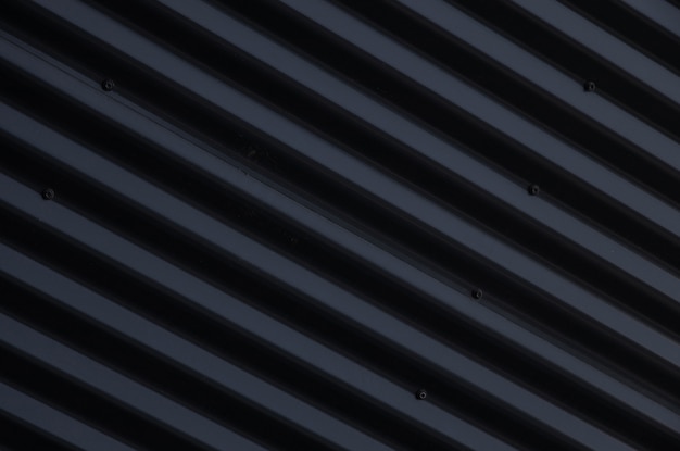 Close-up van metalen glanzend zwart gegolfd oppervlak