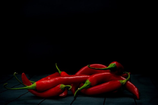 Close-up van rode chili pepers tegen een zwarte achtergrond