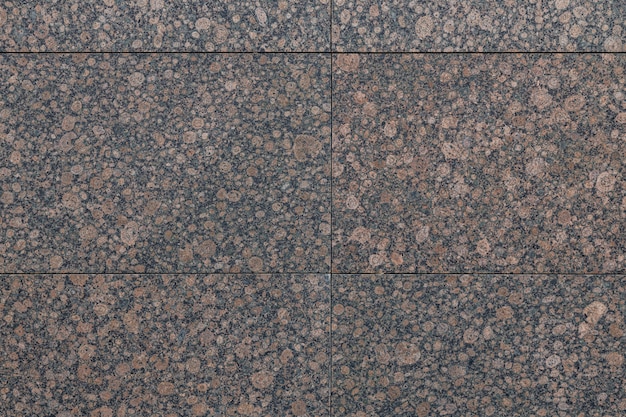 Close-up van vlekkerige kastanjebruine en zwarte graniettegel