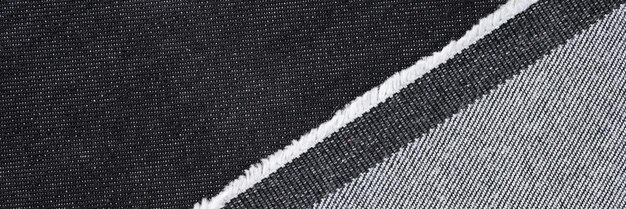 Close-up van zwart en grijs denim stof textuur achtergrond abstract materiaal voor kleding