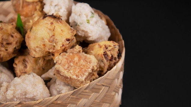 Close up variation of indonesian fritters in a rattan bowl