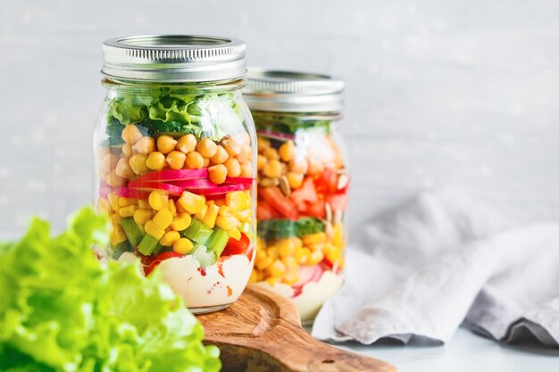 Close-up of various food in glass jar on table