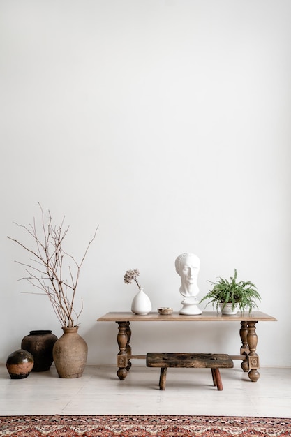 Close-up of vase on table against wall